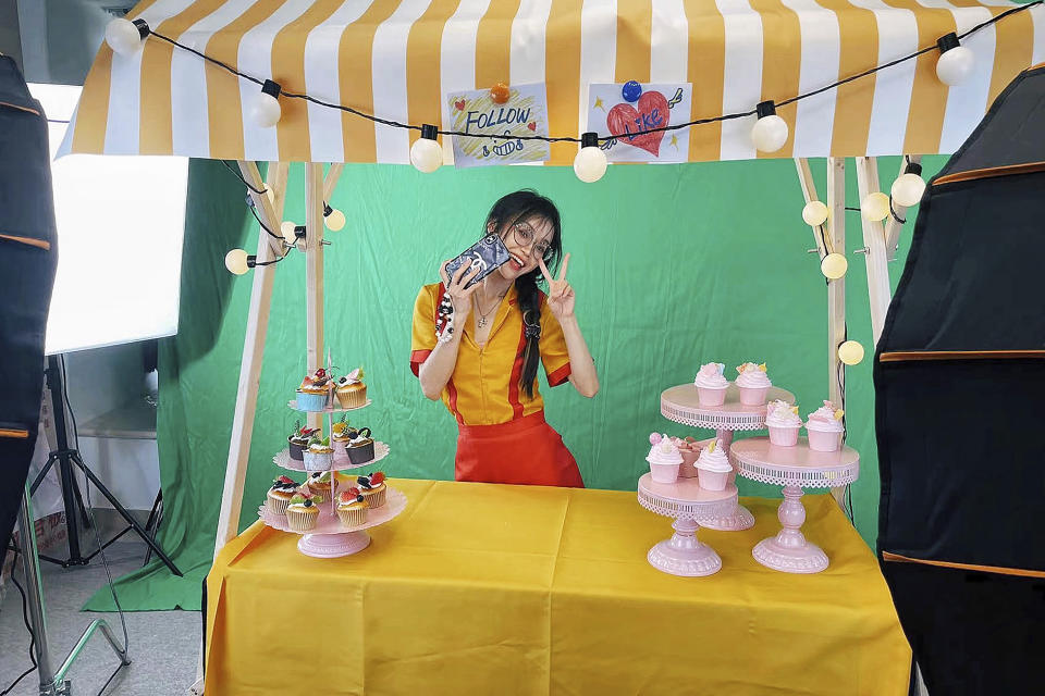 In this photo released by Oreo Deng, Oreo Deng, a former English tutor who sells jewelry to U.S. customers by livestreaming on TikTok, poses for a photo in her studio in Shenzhen in southern China's Guangdong province in June 2023. Chinese livestreamers have set their sights on TikTok shoppers in the U.S. and Europe, hawking everything from bags and apparel to crystals with eyes on a potentially lucrative market, despite uncertainties over the Chinese social media platform's future in the U.S. and elsewhere. (Oreo Deng via AP)