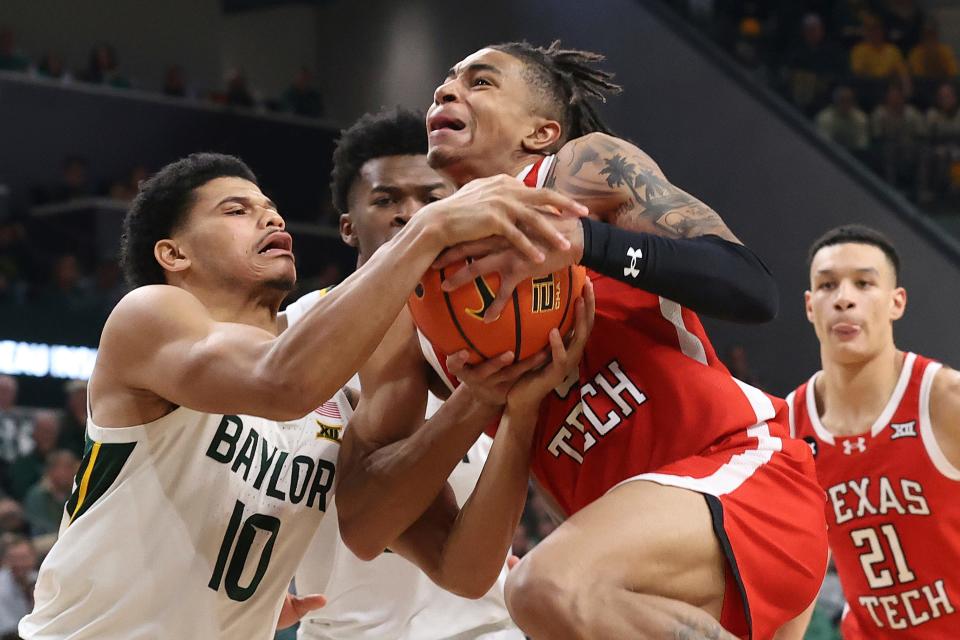 Texas Tech guard Chance McMillian (0), right, and Baylor guard RayJ Dennis (10), left, battle for control of the ball during the Big 12 basketball game, Tuesday, Feb. 6, 2024, in Waco, Texas.