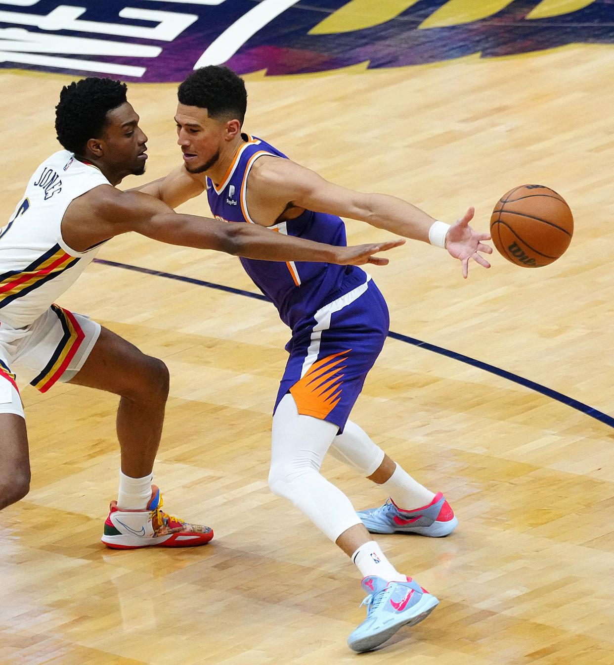 Pelicans' Herbert Jones (6) pokes the ball away from Suns' Devin Booker (1) during Game 6 of the first round of the Western Conference Playoffs.