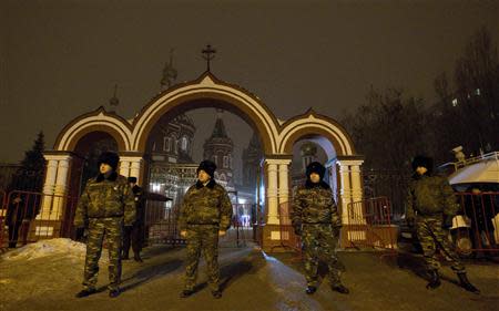 Russian Cossacks, who started regular patrols within the city in the wake of recent suicide attacks, stand guard in front of the Kazan Orthodox Cathedral in the southern Russian city of Volgograd, January 7, 2014. REUTERS/Vasily Fedosenko