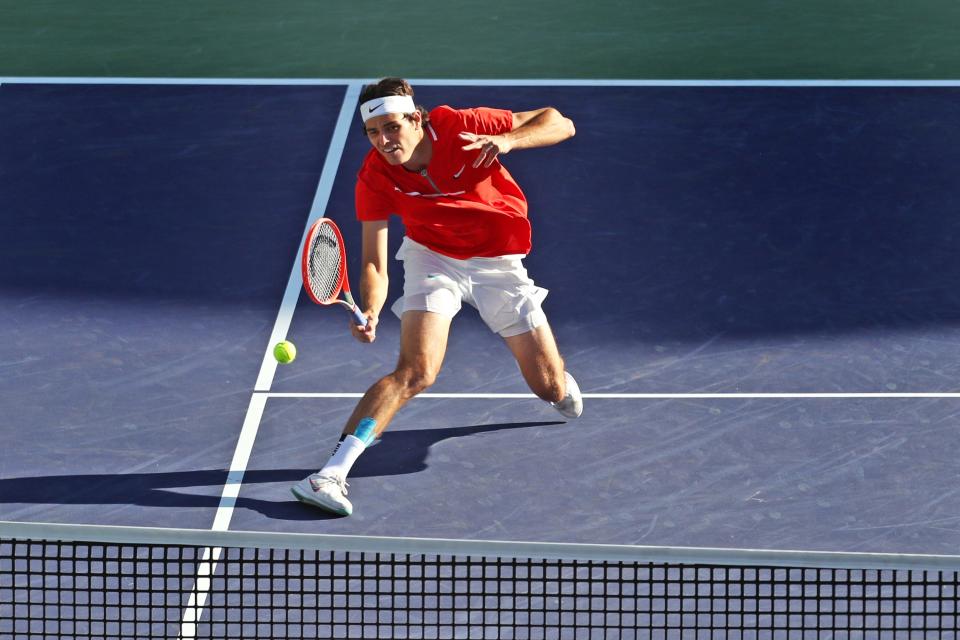 American Taylor Fritz runs down a volley shot by Rafael Nadal of Spain during the men's final at the BNP Paribas Open in Indian Wells, Calif., on Sunday, March 2022.