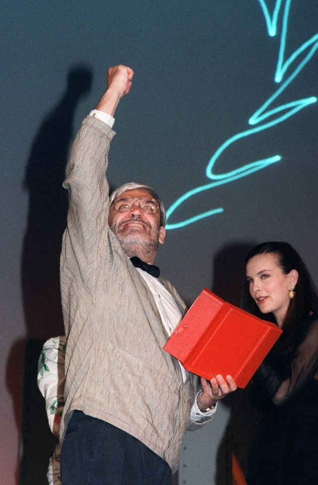 French director Maurice Pialat lifts his fist in response to jeers from the crowd at the Cannes Film Festival on May 19, 1987