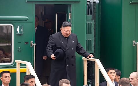 Kim was pictured smiling as he stepped off the train - Credit: Alexander Safronov/TASS via Getty Images