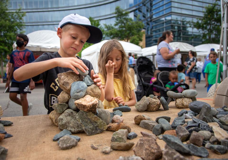 Nash Eddie, 7, and his sister Sloane Eddie, 5 build at the Des Moines Arts Festival in downtown Des Moines in 2021.