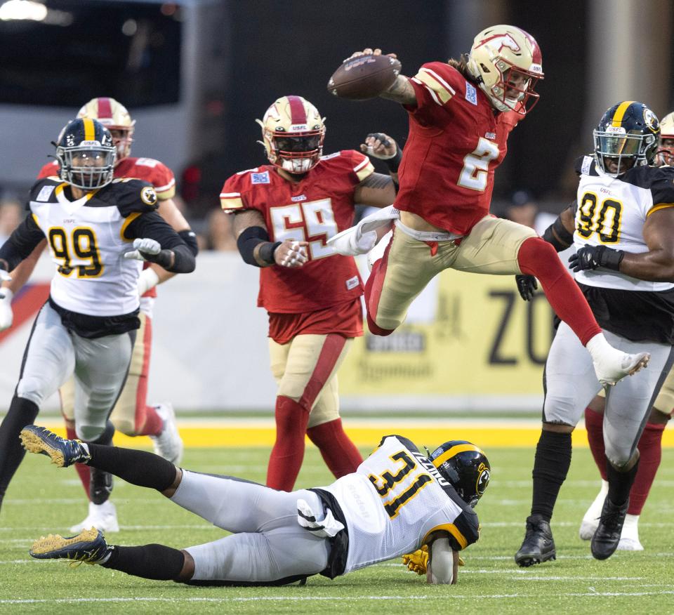 Birmingham Stallions quarterback Alex McGough leaps Pittsburg Maulers defender Kyahva Tezino for a first down in the first half in the USFL Championship Game at Tom Benson Hall of Fame Stadium, Saturday, July 1, 2023, in Canton.