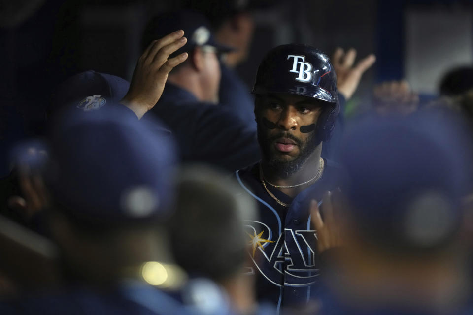 Tampa Bay Rays' Yandy Diaz celebrates in the dugout after hitting a two-run home run against the Toronto Blue Jays during the sixth inning of a baseball game Friday, Sept. 29, 2023, in Toronto. (Chris Young/The Canadian Press via AP)
