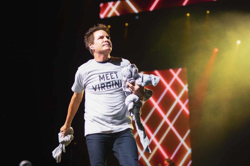 Train lead singer Pat Monahan tosses shirts that read “Meet Virginia” into the crowd at PNC Music Pavilion.