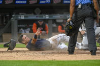 Minnesota Twins' Gio Urshela, left, looks at home plate umpire CB Bucknor, who prepares to call Urshela out after a tag by Detroit Tigers catcher Tucker Barnhart during the fourth inning of a baseball game Tuesday, May 24, 2022, in Minneapolis. (AP Photo/Craig Lassig)