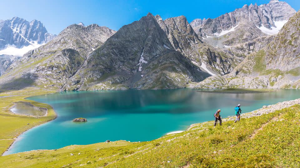 Trekkers hike alongside beautiful Krishansar Lake. - Vivek_Renukaprasad/iStock Editorial/Getty Images