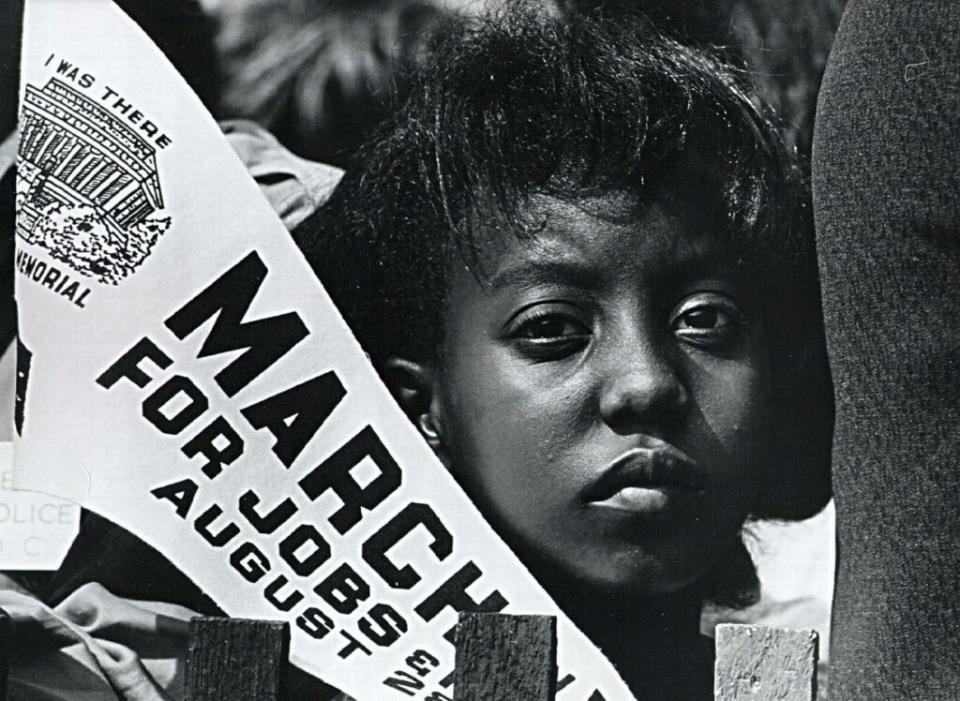 380887 34: A young African American woman listens during a civil rights rally at the Lincoln Memorial August 28, 1963 in Washington. (Photo by National Archive/Newsmakers)