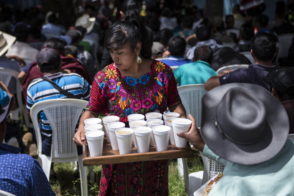 A woman serves drinks during a political rally of the National Unity of Hope party in San Martin Jilotepeque, Guatemala, Sunday, August 4, 2019. Guatemalans are heading to vote on Sunday for new president amid migration fears, corruption and poverty.(AP Photo/ Oliver de Ros)