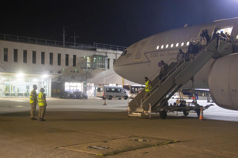 In the photo provided by the Ministry of Defence, the first flight carrying evacuated personnel of British Embassy staff and British Nationals, arriving at RAF Brize Norton, England, early Monday Aug. 16, 2021. Taliban forces have toppled the Western-backed Afghanistan government, as international nations scramble to evacuate diplomats, employees and their families from Kabul. (Sharron Flyod/Ministry of Defence via AP)