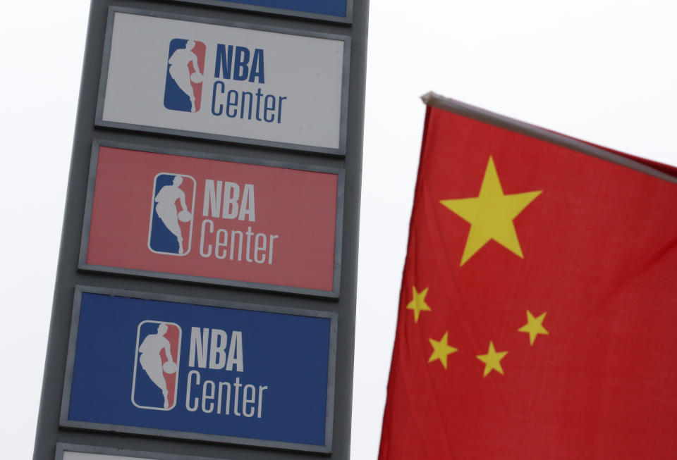 NBA logos are seen next to a Chinese national flag outside a NBA-themed lifestyle complex on the outskirts of Tianjin, China, October 10, 2019. REUTERS/Jason Lee