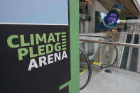 A sign inside Climate Pledge Arena is shown Wednesday, Oct. 20, 2021, during a media tour ahead of the NHL hockey Seattle Kraken's home opener Saturday against the Vancouver Canucks in Seattle. The historic angled roof of the former KeyArena was preserved, but everything else inside the venue, which will also host concerts and be the home of the WNBA Seattle Storm basketball team, is brand new. (AP Photo/Ted S. Warren)