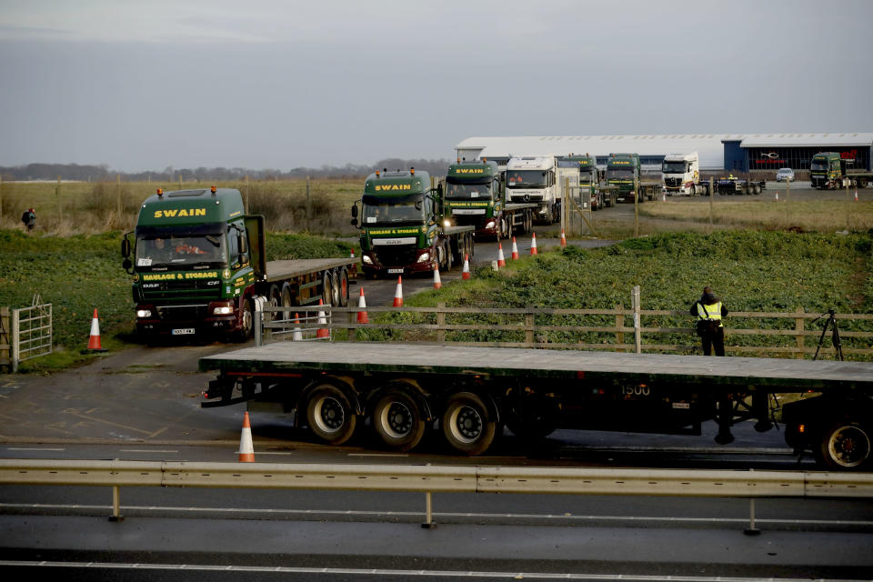 Some 150 trucks leave Manston Airfield during a 'no-deal' Brexit test for where 6,000 trucks could be parked at the airfield near Ramsgate in south east England, Monday, Jan. 7, 2019. The former airfield at Manston could be used as part of a government plan to park some 6,000 trucks to alleviate expected congestion at the channel ports, about 25 miles (40 Km) from the airfield, caused by the reintroduction of customs checks on goods in the event of Britain making a no-deal withdrawal from the European Union at the end of March.(AP Photo/Matt Dunham)
