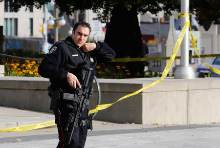 A police officer patrols the scene near the Canada War Memorial following a shooting incident in Ottawa October 22, 2014. REUTERS/Chris Wattie