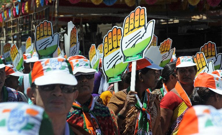 Supporters of Indian Congress party candidate Milind Deora carry cutouts of the Congress party symbol - the hand - during a roadshow in Mumbai, April 12, 2014