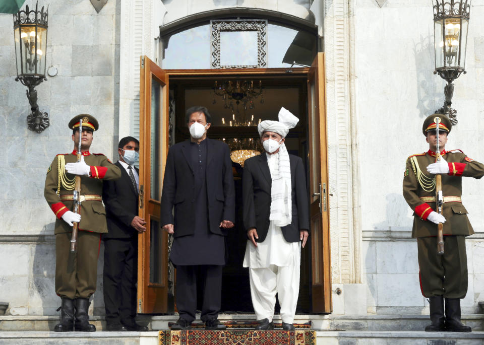 Afghan President Ashraf Ghani, right, and Pakistan Prime Minister Imran Khan stand before a joint news conference at the Presidential Palace in Kabul, Afghanistan, Thursday, Nov. 19, 2020. Ghani on Thursday met with Khan in the capital Kabul to discuss Afghan peace talks, to build trust and strengthen relations between both Afghanistan and Pakistan. (AP Photo/Rahmat Gul)