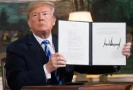 US President Donald Trump signs the document reinstating crippling unilateral sanctions against Iran at the White House on May 8, 2018 after announcing his abandonment of the 2015 nuclear deal