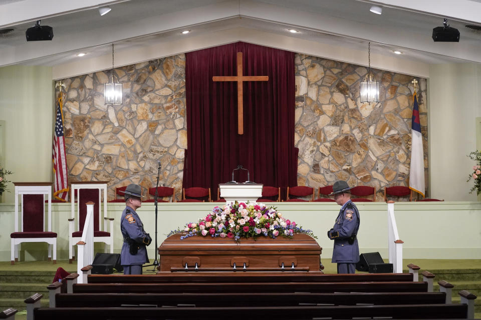 Georgia State Patrol honor guards stand vigil over the casket of former first lady Rosalynn Carter, at Maranatha Baptist Church, in Plains, Ga., Wednesday, Nov. 29, 2023. A cross former President Jimmy Carter fashioned in his wood shop serves as the principal altar ornament. (AP Photo/Alex Brandon)