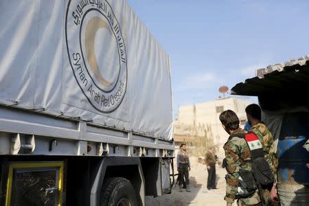 A Red Crescent aid convoy enters the rebel held besieged city of Douma through the last checkpoint in Wafideen Camp, which is controlled by Syrian government forces, Damascus suburbs, Syria February 13, 2016. REUTERS/Omar Sanadiki