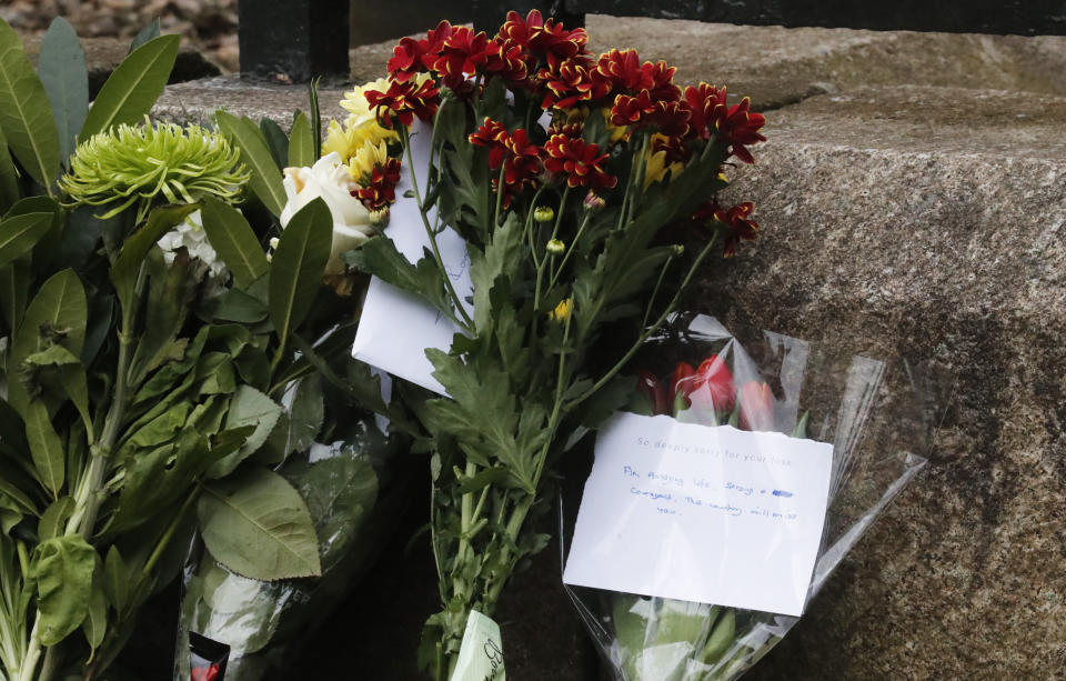 Flowers and other items are left by members of the public outside the gates of Windsor Castle, a day after the death of Britain's Prince Philip, in Windsor, England, Saturday, April 10, 2021. Britain's Prince Philip, the irascible and tough-minded husband of Queen Elizabeth II who spent more than seven decades supporting his wife in a role that mostly defined his life, died on Friday. (AP Photo/Frank Augstein)