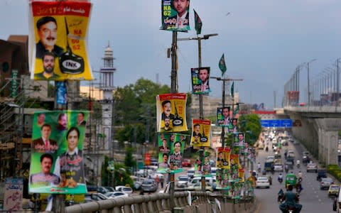 Electoral posters on the highway in Rawalpindi, Pakistan - Credit: AP/Anjum Naveed