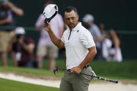 Xander Schauffele waves after completing the second round of the Wells Fargo Championship golf tournament at Quail Hollow on Friday, May 10, 2024, in Charlotte, N.C. (AP Photo/Erik Verduzco)