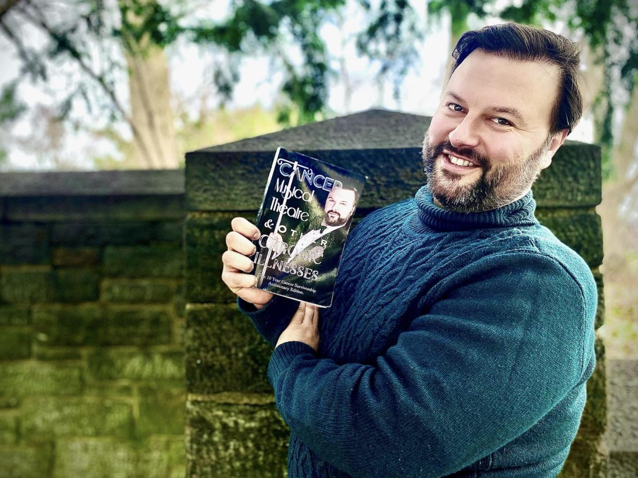 Edward Miskie headshot holding a book