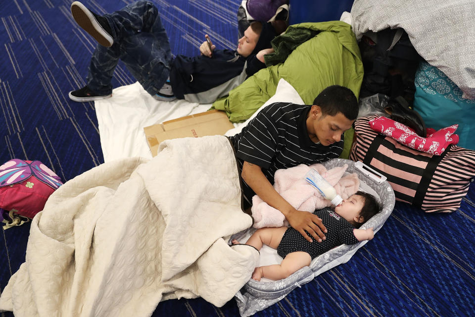 Mark Ocosta and his baby, Aubrey, shelter at the George R. Brown Convention Center.