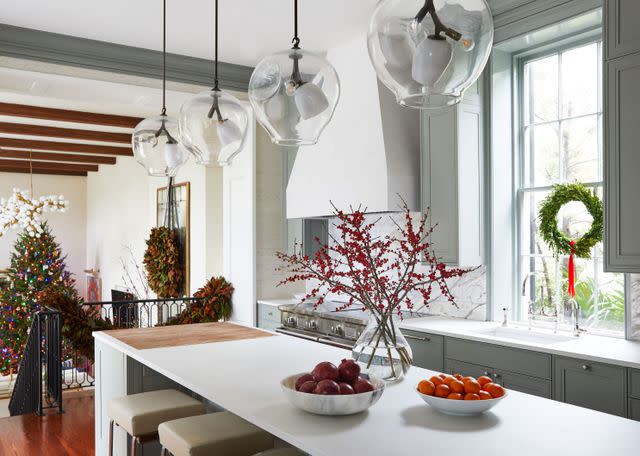 <p>PHOTOGRAPHS BY BRIE WILLIAMS; STYLING BY G. BLAKE SAMS</p> Glass pendants by Lindsey Adelman Studio hang from the ceiling. â€œYou can look through these to the family room, and theyâ€™re sculptural,â€ says Berry.