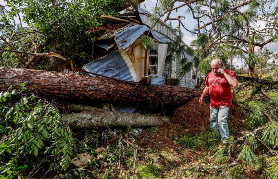 Ron Ganser, 73, inspects the damage to his mobile home caused by a fallen pine tree during Hurricane Idalia in Perry Cove Mobile Home and RV Park in Perry, Florida on Wednesday, August 30, 2023.