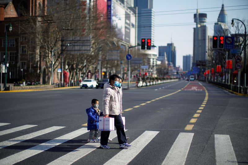 People wearing masks are seen at a main shopping area, in downtown Shanghai