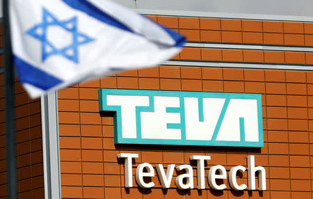 An Israeli flag flutters near the logo of Teva Tech which is part of Teva Pharmaceutical Industries in Neot Hovav, southern Israel December 14, 2017. REUTERS/Amir Cohen