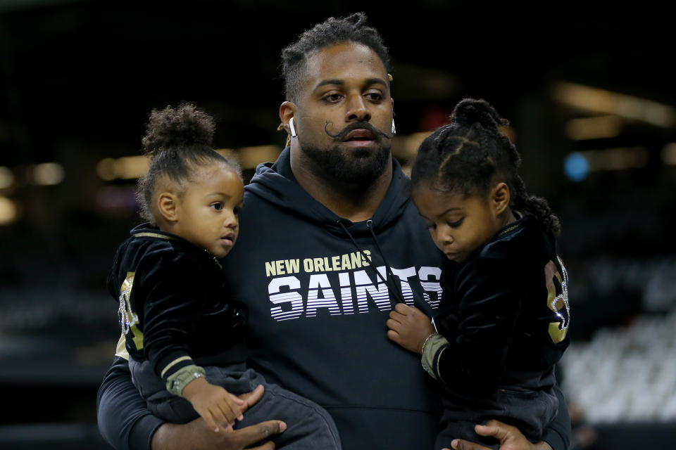 Cameron Jordan #94 of the New Orleans Saints holds his kids prior to the game against the Carolina Panthers at Mercedes Benz Superdome on November 24, 2019 in New Orleans, Louisiana. (Photo by Jonathan Bachman/Getty Images)