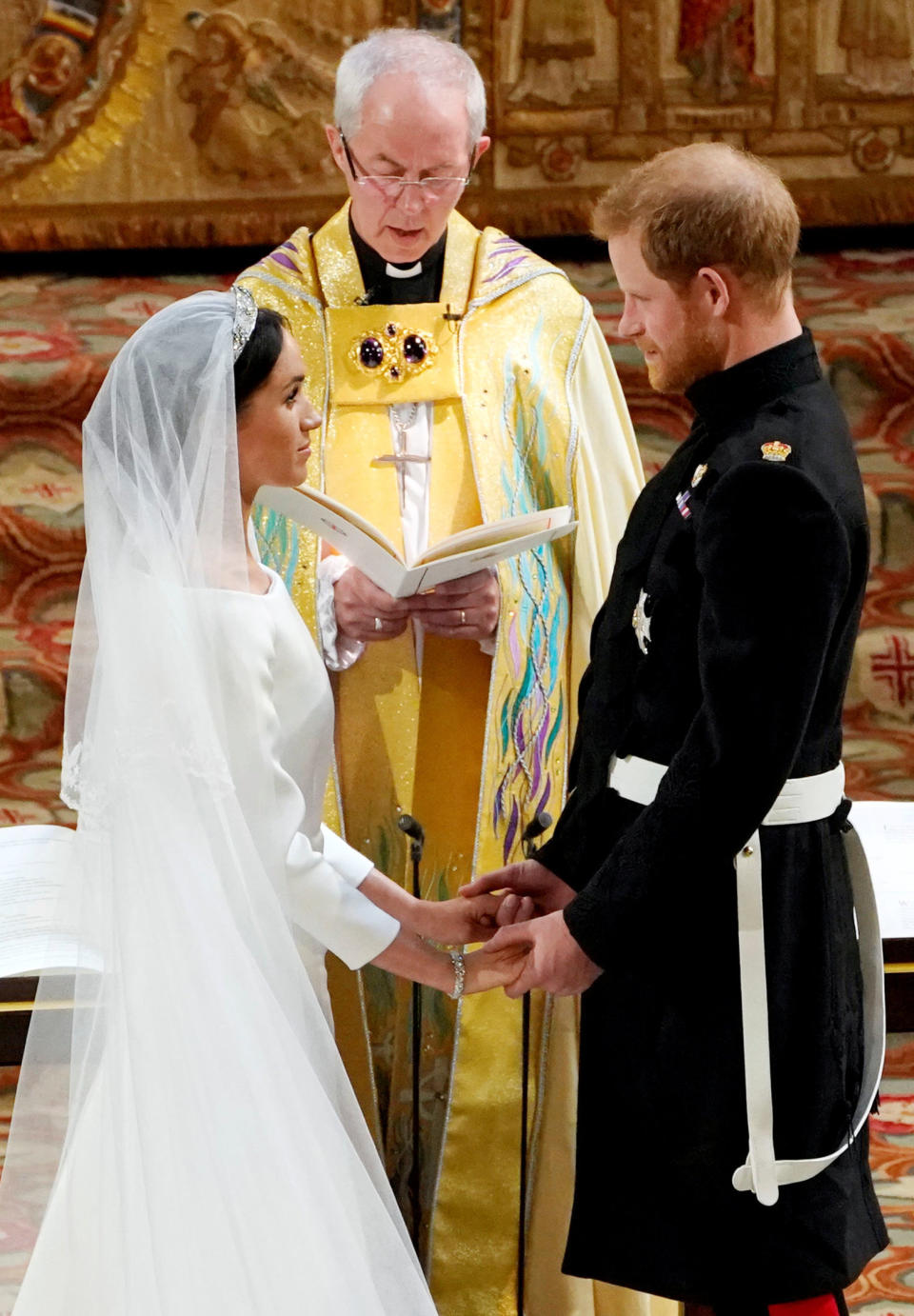 Prince Harry and Meghan Markle exchange vows in St George's Chapel at Windsor Castle during their wedding service, conducted by the Archbishop of Canterbury Justin Welby.