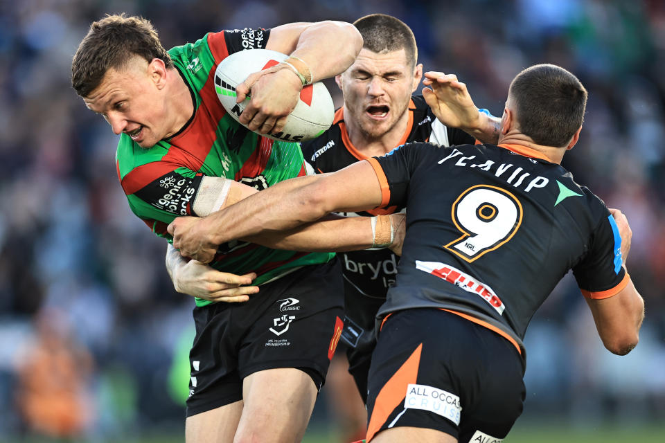 GOSFORD, AUSTRALIA - JULY 20: Jack Wighton of the Rabbitohs
is tackled by John Bateman and Tallyn Da Silva of the Tigers during the round 20 NRL match between South Sydney Rabbitohs and Wests Tigers at Industree Group Stadium, on July 20, 2024, in Gosford, Australia. (Photo by Mark Evans/Getty Images)