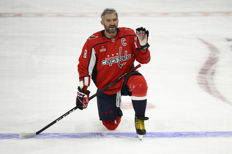 Washington Capitals left wing Alex Ovechkin waves from the ice during warmups for the team's NHL preseason hockey game against the Columbus Blue Jackets, Saturday, Oct. 8, 2022, in Washington. (AP Photo/Nick Wass)