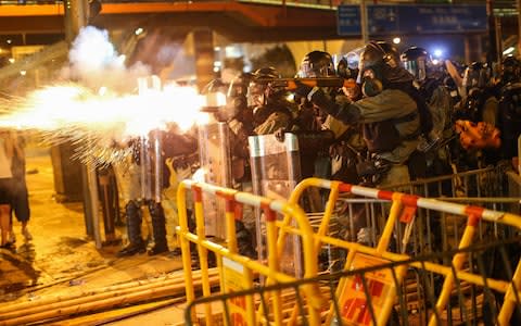 Riot police fire tear gas to disperse protesters taking part in a rally on 28 July - Credit: Rex