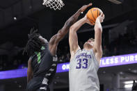 Northwestern forward Luke Hunger (33) shoots against Chicago State guard Wesley Cardet Jr., during the first half of an NCAA college basketball game in Evanston, Ill., Wednesday, Dec. 13, 2023. (AP Photo/Nam Y. Huh)