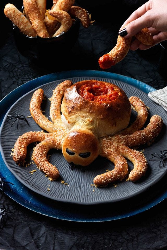<p>This pizza dough dipping bowl will double as a centerpiece for your halloween table — and guests will love scooping parmesan dusted spider legs into marinara sauce. </p><p><em><strong><a href="https://www.womansday.com/food-recipes/food-drinks/recipes/a11906/saucy-spider-hairy-leg-sticks-recipe-123433/" rel="nofollow noopener" target="_blank" data-ylk="slk:Get the Saucy Spider with Hairy Spider Leg recipe.;elm:context_link;itc:0;sec:content-canvas" class="link ">Get the Saucy Spider with Hairy Spider Leg recipe.</a></strong></em></p>