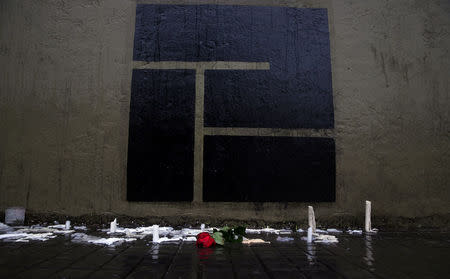 A rose is seen placed in front of the logo of the Instituto Politecnico, a technical high school, where the five Argentine citizens who were killed in the truck attack in New York on October 31 went to school, outside its building in Rosario, Argentina November 2, 2017. REUTERS/Marcos Brindicci