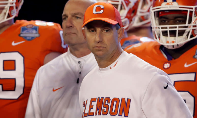 A closeup of Clemson head coach Dabo Swinney standing with his players.