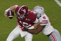 Ohio State linebacker Baron Browning forces a fumble by Alabama quarterback Mac Jones during the first half of an NCAA College Football Playoff national championship game, Monday, Jan. 11, 2021, in Miami Gardens, Fla. (AP Photo/Wilfredo Lee)
