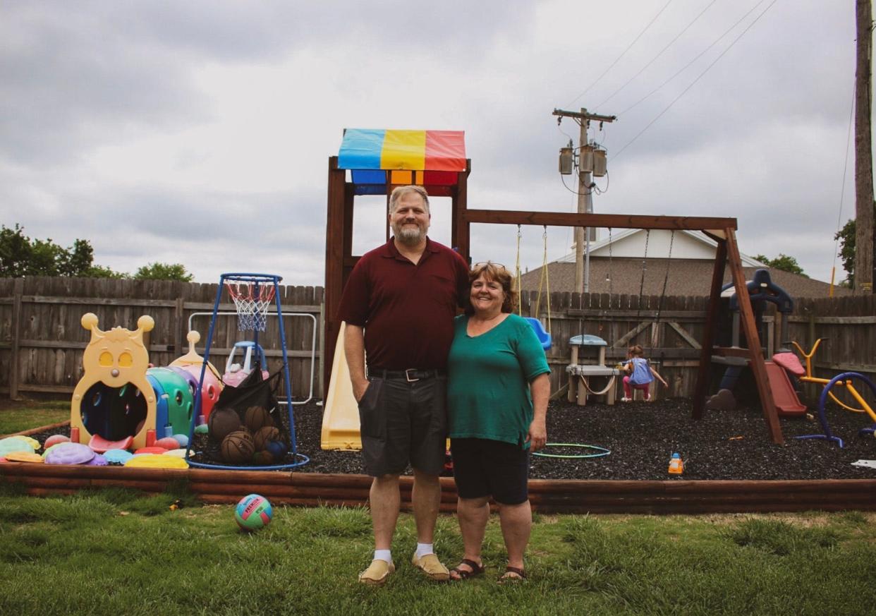 Curt (left) and Kathi (right) Barton stand in the back yard of their Salina home, which doubles as Eagle Wings Daycare.