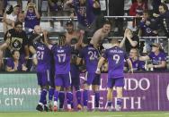 Orlando players celebrate with Benji Michel (19) after he scored a goal during a MSL soccer match in Orlando, Fla., on Tuesday, June 22, 2021. (Stephen M. Dowell /Orlando Sentinel via AP)