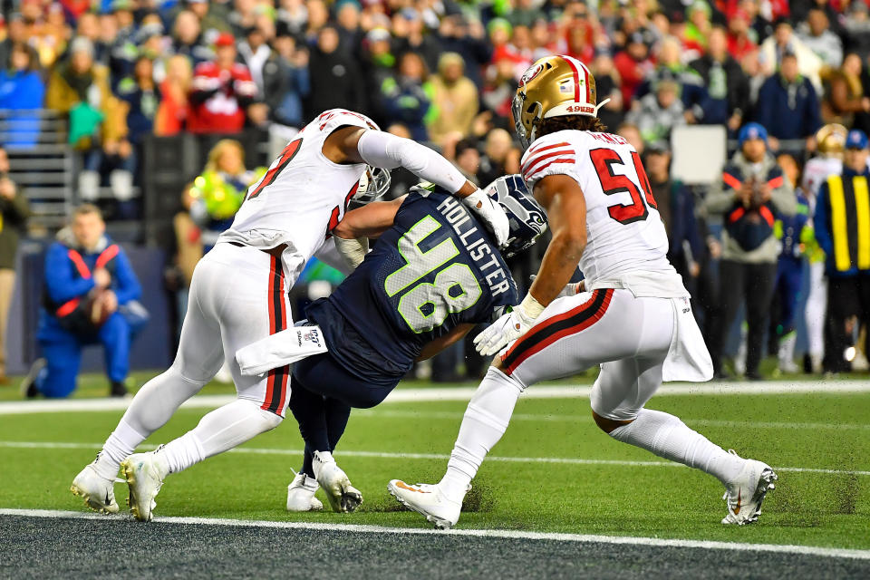 Jacob Hollister of the Seattle Seahawks is stopped inches short of a touchdown by Dre Greenlaw of the San Francisco 49ers in the closing seconds of the regular-season finale. (Photo by Alika Jenner/Getty Images)