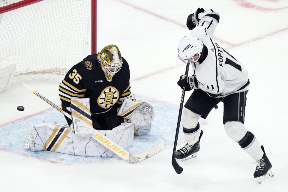 Los Angeles Kings' Anze Kopitar (11) scores the game-tying goal past Boston Bruins' Linus Ullmark (35) during the third period of an NHL hockey game, Saturday, Feb. 17, 2024, in Boston. (AP Photo/Michael Dwyer)