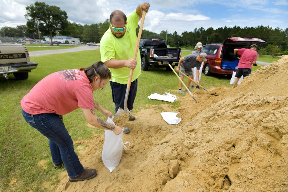 Clay County Public Works employee Joshua Lovelace helps Middleburg resident Destony Jewell fill sandbags at Omega Park when Tropical Storm Elsa was headed toward Northeast Florida on July 6, 2021.