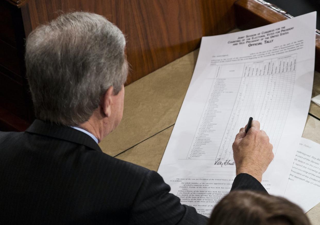 <span class="caption">Missouri Republican Sen. Roy Blunt signs an official tally of the Electoral College votes from the 2016 presidential election, in January 2017.</span> <span class="attribution"><a class="link " href="https://newsroom.ap.org/detail/ElectoralCollege/4fe51dbeb4d243dcb1e5a8508a9c27b3/photo" rel="nofollow noopener" target="_blank" data-ylk="slk:AP Photo/Zach Gibson;elm:context_link;itc:0;sec:content-canvas">AP Photo/Zach Gibson</a></span>